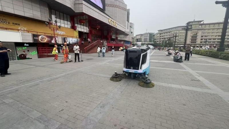 广场上人机协同作业的无人清扫车